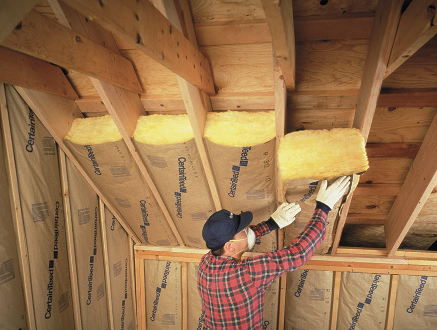 Technician installing home insulation